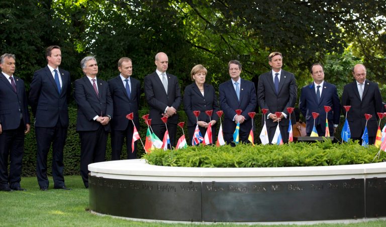 European Union heads of state, from left, Hungarian Prime Minister Viktor Orban, British Prime Minister David Cameron, Austrian Chancellor Werner Faymann , Polish Prime Minister Donald Tusk, Swedish Prime Minister Fredrik Reinfeldt, German Chancellor Angela Merkel, Cypriot President Nicos Anastasiades , Slovenian President Borut Pahor, French President Francois Hollande and Romanian President Traian Basescu stand behind porcelain poppies during the inauguration of a Peace Bench at the Menin Gate in Ypres, Belgium on Thursday, June 26, 2014. Where their countrymen once slaughtered each other with machine guns, artillery and poison gas, the leaders of Britain, Germany and the other member states of the European Union gathered Thursday to solemnly mark the 100th anniversary of the start of World War I and rededicate themselves to peace and working together. (AP Photo/Virginia Mayo)