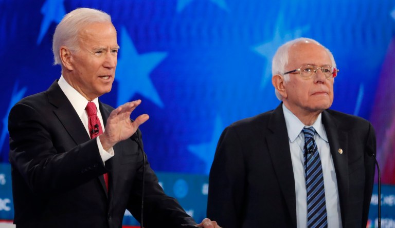 Democratic presidential candidate former Vice President Joe Biden, left, speaks as Democratic presidential candidate Sen. Bernie Sanders, I-Vt., looks on during a Democratic presidential primary debate, Wednesday, Nov. 20, 2019, in Atlanta.