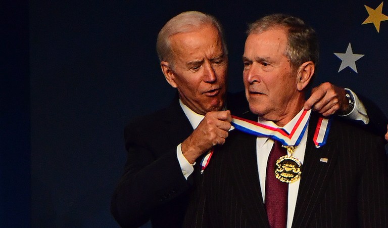 Former U.S. Vice President Joe Biden, from left, bestows a medal on former U.S. President George Bush as former First Lady Laura Bush has the same bestowed by Doug DeVos, Executive Committee Chairman for the National Constitution Center, at the National Constitution Center Sunday, Nov. 11, 2018 in Philadelphia. 