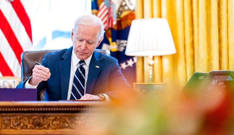 President Joe Biden signs the American Rescue Plan, a coronavirus relief package, in the Oval Office of the White House, Thursday, March 11, 2021, in Washington. 