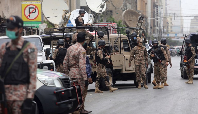 Security personnel surround the Stock Exchange Building in Karachi, Pakistan, Monday, June 29, 2020. Gunmen have attacked the stock exchange in the Pakistani city of Karachi on Monday. Special police forces deployed to the scene of the attack and in a swift operation secured the building.