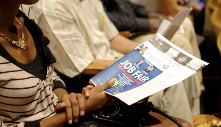 Philoria Richemond of Miami waits in an auditorium for her number to be called at a jobs fair hosted by the Congressional Black Caucus in Miami, Tuesday, Aug. 23, 2011. The fair is aimed at lowering the especially high rate of unemployment in the black community. 