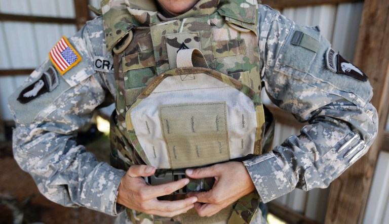 Sgt. Bobbie Crawford removes her new body armor after training on a firing range on Tuesday, Sept. 18, 2012, in Fort Campbell, Ky. Female soldiers from 1st Brigade Combat Team, 101st Airborne Division are field testing the first Army body armor designed to fit women's physiques in preparation for their deployment to Afghanistan this fall.