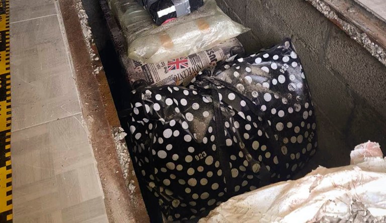 In this undated image provided by the Romanian Police a view of some 200 rare and valuable books discovered Wednesday, Sept. 16, 2020 hidden under a house in rural Romania, displayed in a garden in north eastern Romania. Romanian police have uncovered a trove of "irreplaceable" books including first editions of works by Galileo Galilei and Isaac Newton that were stolen in a daring 2017 heist from a warehouse in London, police and the European Union's judicial cooperation agency said Friday, Sept.18, 2020.