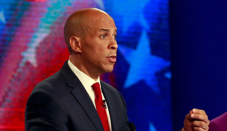 Democratic presidential candidate Sen. Cory Booker, D-N.J., gestures as former Housing and Urban Development Secretary Julian Castro listens, during s Democratic primary debate hosted by NBC News at the Adrienne Arsht Center for the Performing Art, Wednesday, June 26, 2019, in Miami.