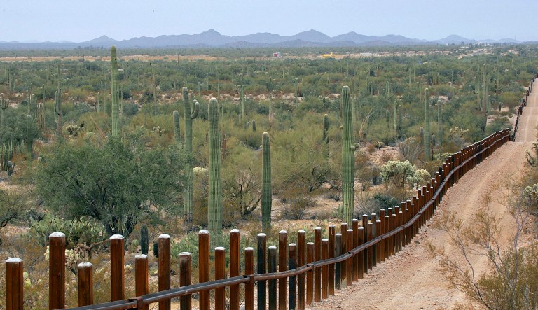 This Feb. 17, 2006 file photo shows the international border line made up of bollards: irregular, concrete-filled steel poles, seperating Mexico, left from the United States, in the Organ Pipe National Monument near Lukeville, Ariz.