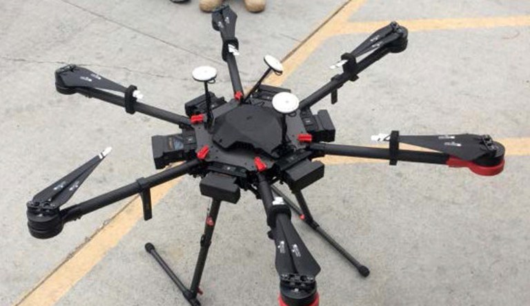 This undated photo provided by the U.S. Border Patrol shows a 2-foot-high drone that a border patrol agent spotted swooping over the border fence on Tuesday, Aug. 8, 2017, near a San Diego border crossing. Authorities have arrested a man they say used the drone to fly drugs across the Mexican border into California.