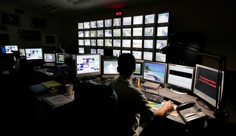 In this July 21, 2009 photo, Daniel Hafich watches a wall of monitors in a remote video surveillance room in a Border Patrol facility in Blaine, Wash. 