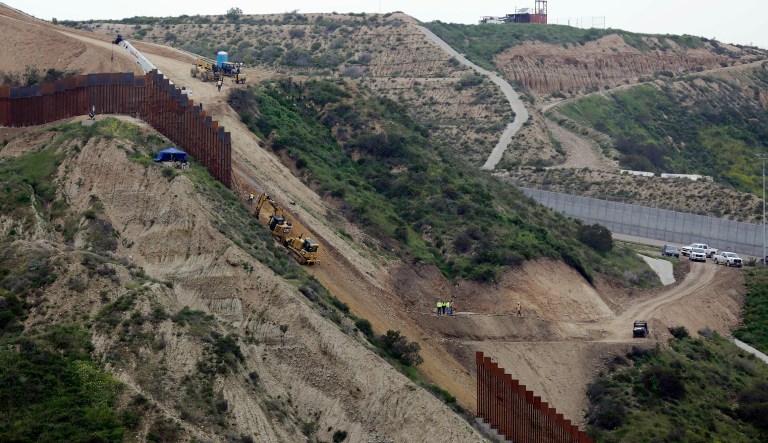Construction crews replace a section of the primary wall separating San Diego, above right, and Tijuana, Mexico, below left, Monday, March 11, 2019, seen from Tijuana, Mexico.