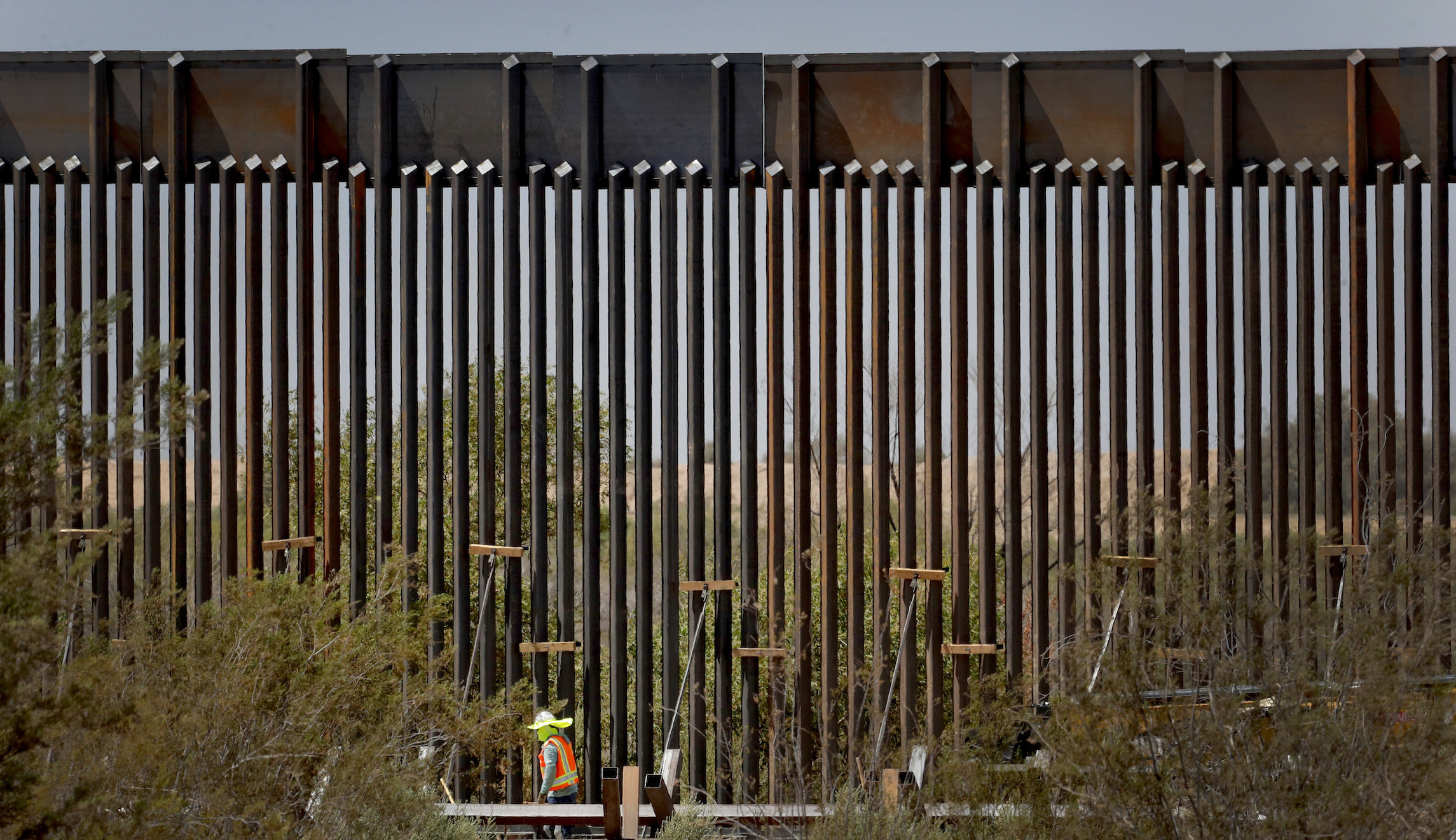 Rock climbers competing to scale ‘impossible to climb’ border wall