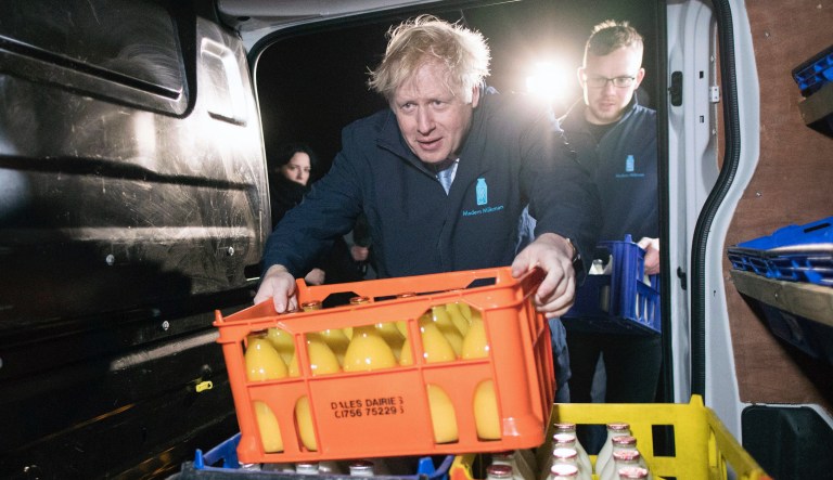 Prime Minister Boris Johnson loads a crate into a delivery van during a visit to Greenside Farm Business Park in Leeds, ahead of Thursday's General Election. PA Photo. Picture date: Wednesday December 11, 2019.