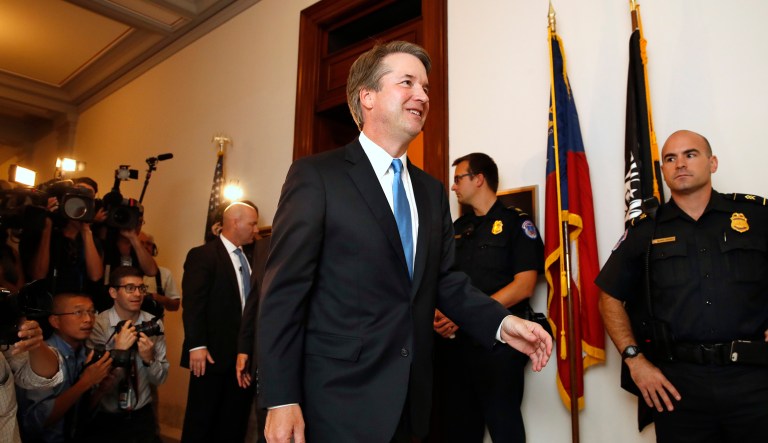 Supreme Court nominee Judge Brett Kavanaugh, center, walks to the office of Sen. Johnny Isakson, R-Ga., for a meeting Tuesday, July 17, 2018, on Capitol Hill in Washington.