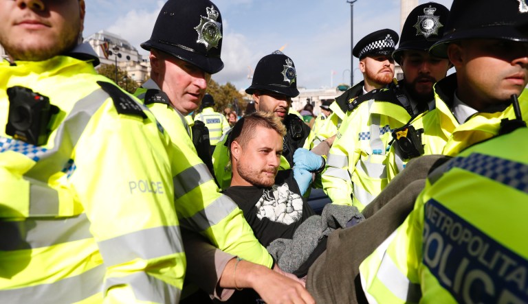 Paralympic medalist climbs on top of plane to protest climate change at airport