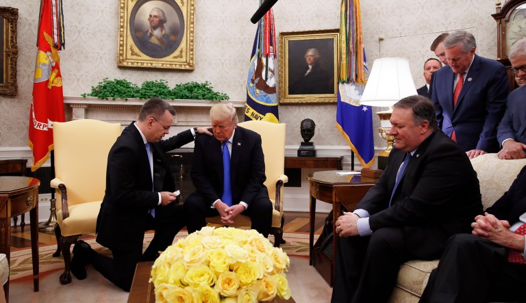 President Donald Trump prays with American pastor Andrew Brunson in the Oval Office of the White House on Oct. 13, 2018.
