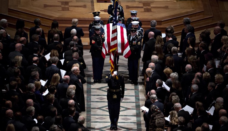 The flag-draped casket of former President George H.W. Bush is carried out of the National Cathedral following a state funeral service in Washington, D.C., on Wednesday, Dec. 5, 2018.