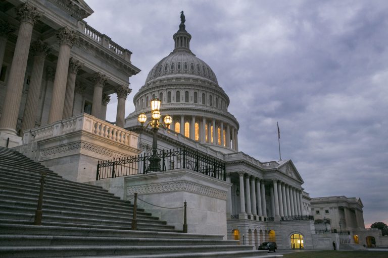 Dark clouds loom over the Capitol building early on Tuesday morning, the first day of the government shutdown, Tuesday, October 1st, 2013