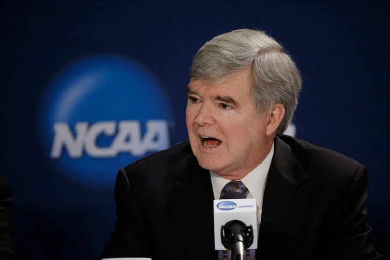 FILE - In this April 6, 2014, file phot, NCAA President Mark Emmert answers a question at a news conference in Arlington, Texas. Testifying in a landmark antitrust lawsuit filed against his organization, Emmert said Thursday, June 19, 2014, he believes there is a clear difference between the proposal to pay athletes a few thousand more dollars a year and giving them the equivalent of a salary. Emmert's testimony came in a much-anticipated appearance as the NCAA tries to convince U.S. District Judge Claudia Wilken that its system of so-called amateurism is not anti-competitive and is the best model for regulating college sports. (AP Photo/David J. Phillip, File)
