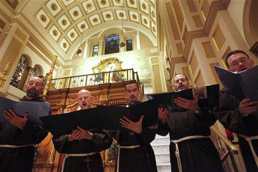 A choir of friars warms up before a ceremony honoring St. Francis inside the Memorial Church of the Holy Sepulcher at the Franciscan Monastery of the Holy Land, on the 800th anniversary of the Franciscan Order, in Washington. (AP Photo/Jacquelyn Martin, File)