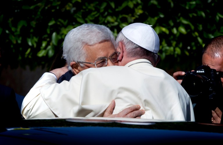 Palestinian President Mahmoud Abbas, left, and Pope Francis hug each other as Francis arrives at the Palestinian Authority headquarters in the West Bank city of Bethlehem on Sunday, May 25, 2014. Francis landed Sunday in the West Bank town of Bethlehem in a symbolic nod to Palestinian aspirations for their own state as he began a busy second day of his Mideast pilgrimage. (AP Photo/Nasser Nasser)