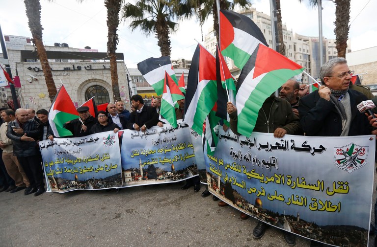 Palestinian protesters hold flags and chant slogans during a demonstration against moving the U.S. embassy to Jerusalem, in the West Bank city of Ramallah, Thursday Jan. 19, 2017. (AP Photo/Majdi Mohammed)