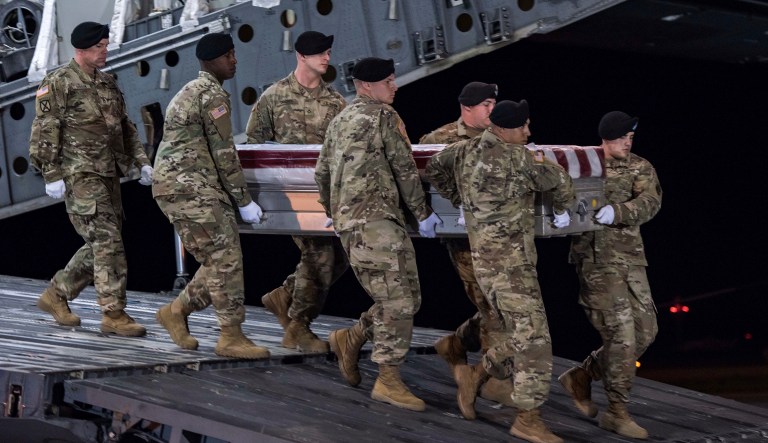 In this image provided by the U.S. Army, a carry team of soldiers from the 3d U.S. Infantry Regiment (The Old Guard), carry the transfer case during a casualty return. (Pfc. Lane Hiser/U.S. Army via AP)
