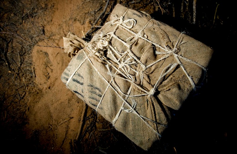 A bundle of confiscated marijuana waits to be picked up, documented, and destroyed by the Pima County Sheriff Department along Highway 286 and 86 in Tucson, Arizona, Friday, June 12, 2009. U.S. officials confirmed Wednesday evening they seized 3,000 pounds of marijuana in the sting operation. (Bloomberg/Matt Nager)
