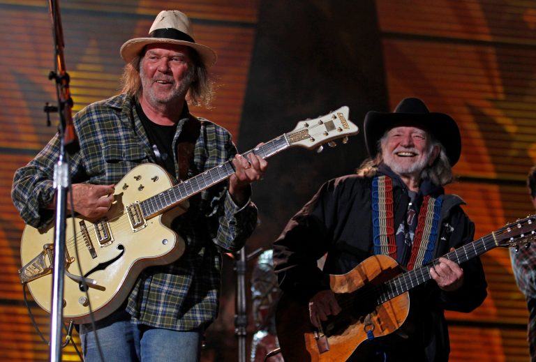 Neil Young, left, and Willie Nelson perform during the 25th anniversary Farm Aid concert Saturday, Oct. 2, 2010, in Milwaukee. (AP Photo/Jeffrey Phelps)