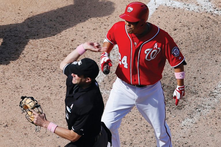Rob Carr/Getty Images
Umpire John Tumpane ejects Nationals catcher Kurt Suzuki for arguing balls and strikes in Washington's 2-1 loss to the Cubs on Sunday.