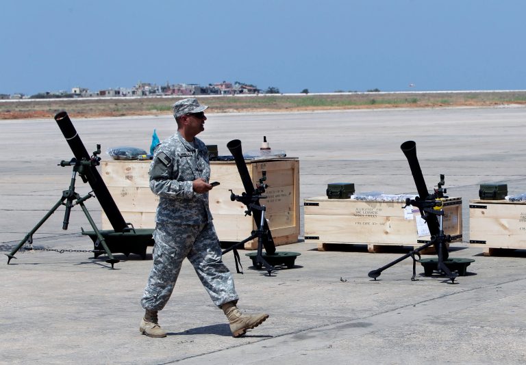 A U.S. soldier walks past mortars at the Rafik Hariri International Airport in Beirut, Lebanon, Friday, Aug. 29, 2014. The United States has delivered the first shipment of weapons to Lebanon to help bolster its military as it faces a growing threat from Islamic militants amid the fallout from neighboring Syria's civil war. (AP Photo/Bilal Hussein)