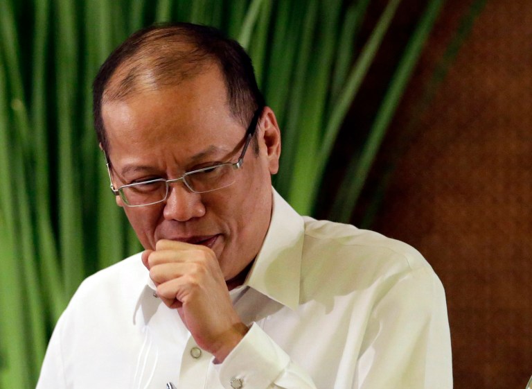 FILE - In this July 14, 2014 file photo, Philippine President Benigno Aquino III walks to interact with his guests following his address to the nation in a live broadcast from the Presidential Palace in Manila, Philippines. The Philippine president, a known smoker, has signed a law that requires tobacco companies to put scary health warnings on cigarette packs in a country where tens of thousands of people die every year from tobacco-linked diseases. President Aquino's spokesman, Herminio Coloma Jr., said Sunday, July 20, 2014 that the Philippine leader signed the law 
