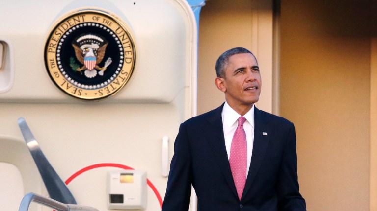 President Obama briefly glances up toward the sunset after arriving at Seattle-Tacoma International Airport in Seattle on Sunday. Obama is traveling on a three-day West Coast swing to Seattle, San Francisco and Los Angeles that will feature a bit of official business, but mostly fundraising for the Democratic party. (AP Photo/Elaine Thompson)