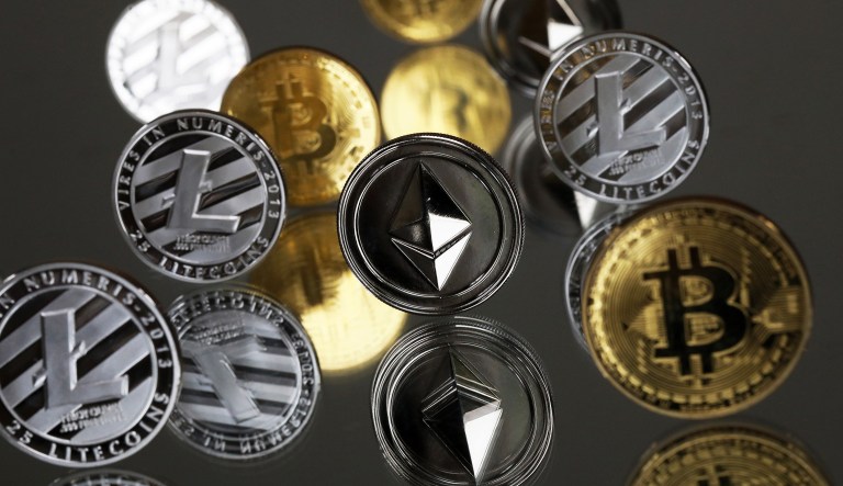 A collection of bitcoin, litecoin, and ethereum tokens. The Financial Stability Oversight Council, chaired by Treasury Secretary Steven Mnuchin, has set up a working group on cryptocurrencies. The group comprising top federal regulators would examine the potential for speculation on cryptocurrencies to hurt consumers and for the digital currencies to be used for illicit purposes.(Chris Ratcliffe/Bloomberg)