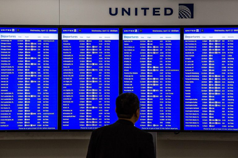 A passenger views a departures board inside the United terminal at Newark Liberty International Airport. After years of focusing on larger markets like Newark, the third-largest U.S. carrier is expanding in higher-yield regional markets. (Timothy Fadek/Bloomberg)