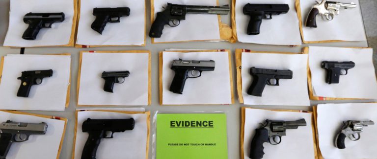Chicago police display some of the nearly 3,400 illegal firearms the have confiscated so far this year in their battle against gun violence during a news conference in Chicago. (AP Photo/M. Spencer Green)