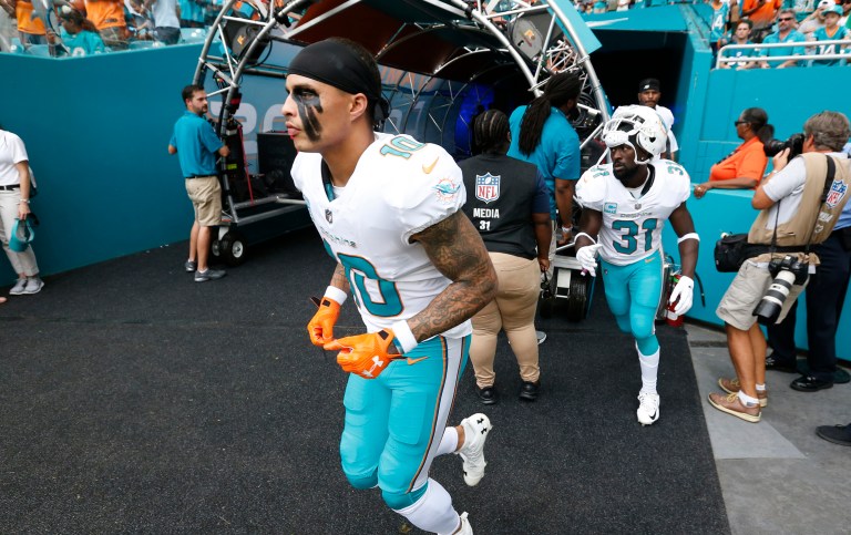 Rather than 400 officers, just 270 were expected to help maintain order as the New York Jets played the home team Miami Dolphins. (AP Photo/Wilfredo Lee)