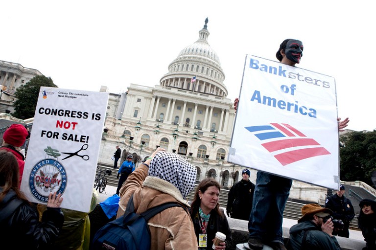 Protesters with Occupy Congress hold up a signs in front of the U.S. Capitol in Washington, D.C. (Joshua Roberts/Bloomberg)