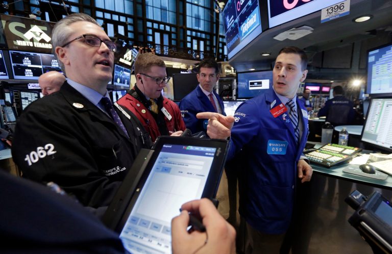 Specialist Joseph Mastrolia, right, works with traders at his post on the floor of the New York Stock Exchange Wednesday, Jan. 28, 2015. (AP Photo/Richard Drew)