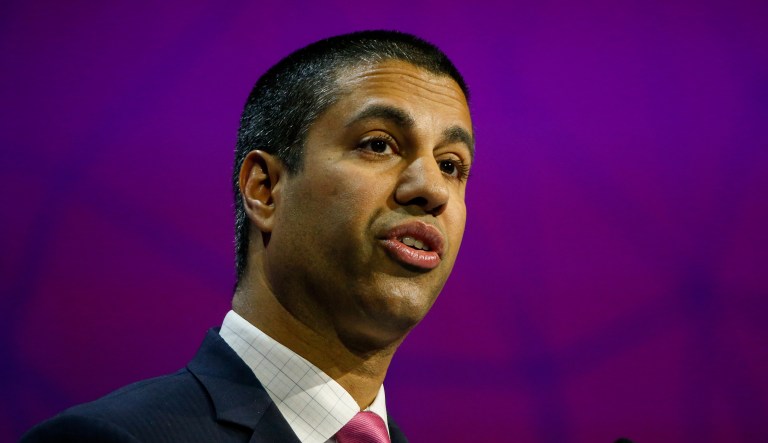 Pai announced last week the FCC will vote Dec. 14 to roll back net neutrality rules. Supporters of the net neutrality rules have put cardboard signs outside of Pai's Virginia home criticizing him for his plan. (Pau Barrena/Bloomberg)