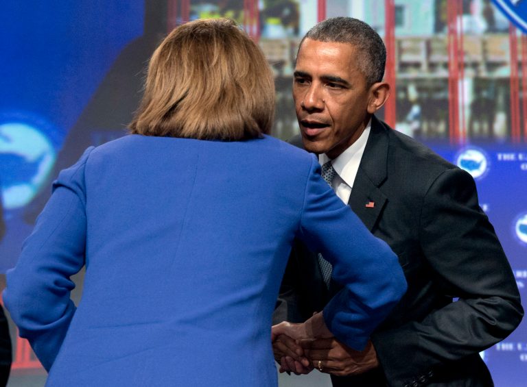 President Barack Obama leans into to talk to and kiss House Minority Leader Nancy Pelosi of Calif., after speaking at the Annual Meeting of the U.S. Conference of Mayors in San Francisco, Friday, June 19, 2015. (AP Photo/Carolyn Kaster)