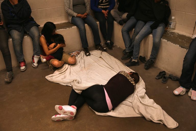 MCALLEN, TX - SEPTEMBER 08:  Women and children wait in a holding cell at a U.S. Border Patrol processing center after being detained by agents near the U.S.-Mexico border on September 8, 2014 near McAllen, Texas. Thousands of immigrants, many of them families and unaccompanied minors, continue to cross illegally into the United States, although the numbers are down from a springtime high. Texas' Rio Grande Valley area is the busiest sector for illegal border crossings into the United States.  (Photo by John Moore/Getty Images)