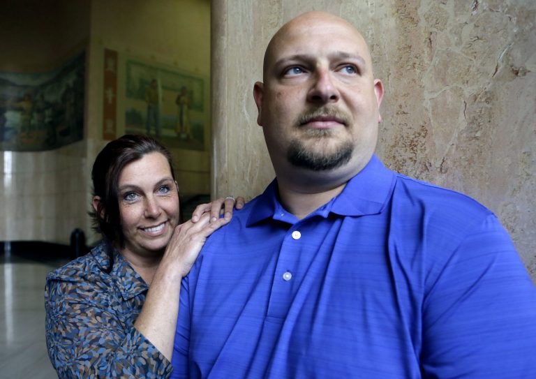 Former Spartanburg, S.C., sheriff's deputy Brandon Bentley, poses for a photo with his wife, retired Salem police department officer Kelly Clark, in Salem, Ore.  Bentley's appeal to the South Carolina Supreme Court on a post-traumatic stress disorder claim was denied, stating the law did not provide mental health benefits for officers because they are trained in the use of deadly force and know that they may have to use it. (AP Photo/Don Ryan)