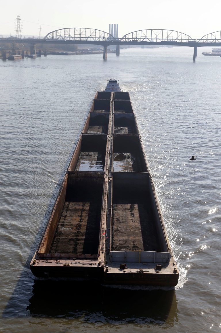 FILE - In this  Nov. 16, 2012 file photo, a barge powers its way up the Mississippi River in St. Louis. Environmental groups have sued the Army Corps of Engineers over the agency's use of man-made structures meant to keep the Mississippi River navigable. The federal lawsuit was filed Thursday, May 22, 2014 in Illinois' East St. Louis. Plaintiffs including the National Wildlife Federation claim the techniques provoke flooding as seen during historic inundations four times in the past two decades. (AP Photo/Jeff Roberson, File)