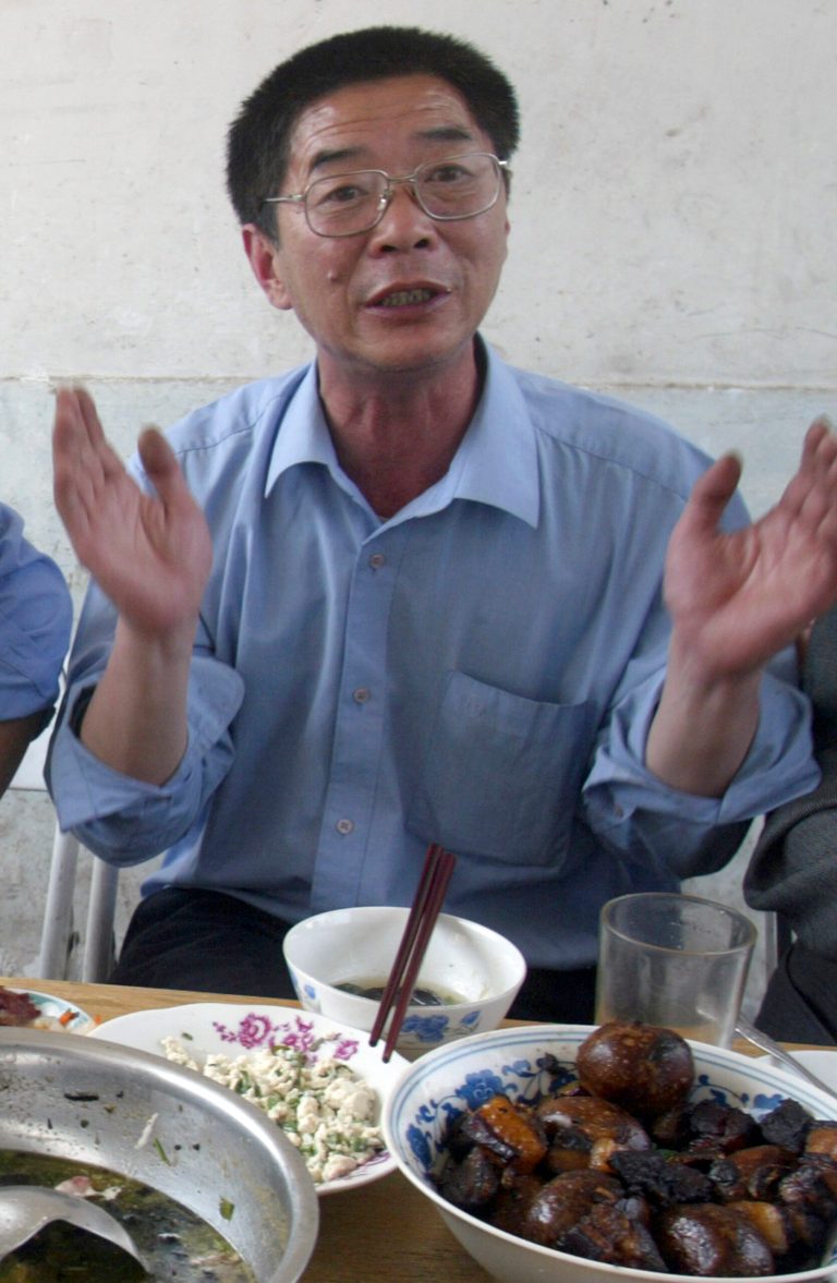 In this photo taken April 11, 2004, Chinese dissident Xiang Nanfu shares an Easter meal with other Chinese dissidents at a brick home in Houbaihujian village, on the outskirts of Beijing. Xiang who supplied information to to a dissident-run U.S.-based news website has been detained on charges he made up stories that disparaged the Chinese government, police announced Tuesday, May 13, 2014. (AP Photo/Ng Han Guan)