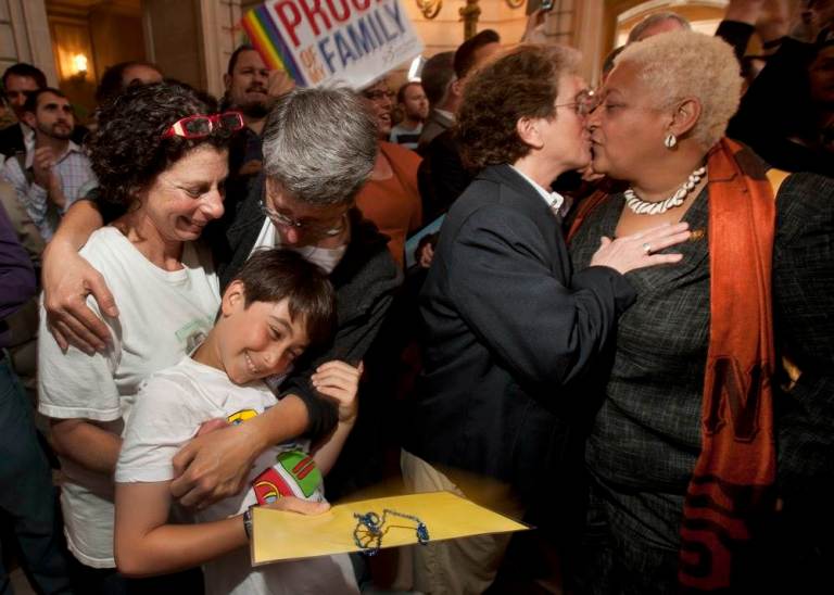 Sue Rochman, left, and Robin Romdalvik hug their son Maddox Rochman-Romdalvik, 8, at San Francisco's City Hall, after the U.S. Supreme Court ruling cleared the way for same-sex marriage in California on June 26. The decision cleared the way for the Obama administration to provide spousal benefits to legally married same sex couples who work for the government. AP Photo