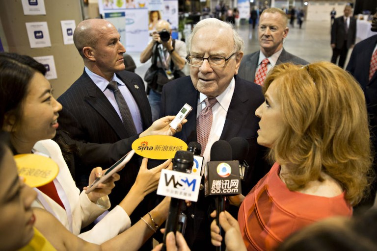 Warren Buffett talks with reporters before Berkshire Hathaway's annual meeting in Omaha, Neb., in May 2017. The company has a war chest of about $116 billion to fund dealmaking this year. (Daniel Acker/Bloomberg)