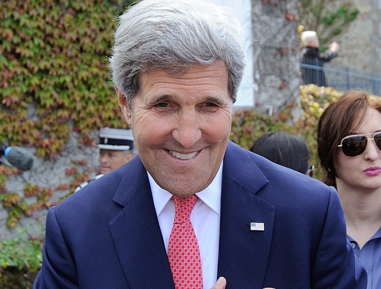 Secretary of State John Kerry greets residents during the inauguration of the Tony Vaccaro square, in front of Saint-Briac-sur-Mer city hall, western France, Saturday, June, 7, 2014. (AP Photo/ Jean Sebastien Evrard, Pool)