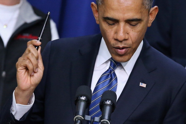 WASHINGTON, DC - NOVEMBER 28:  U.S. President Barack Obama holds a pen while saying he is ready to sign legislation taht would extend tax cuts for middle class people during an event in the Eisenhower Executive Office Building November 28, 2012 in Washington, DC. With the end-of-the-year 