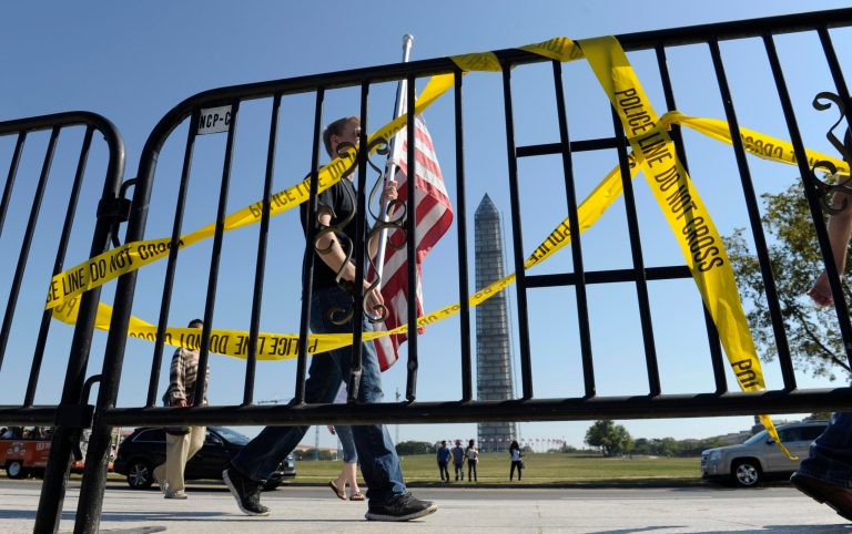Pedestrians walk past a barricade preventing them from entering the World War II Memorial on Wednesday. (AP/Susan Walsh)