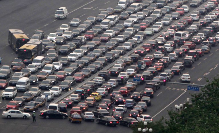 In this photo taken Monday, April 25, 2011, cars clog a main thoroughfare in Beijing, China. China's government plans to take 5 million older, polluting vehicles off the road this year in an effort to revive stalled progress toward cleaning up smog-choked cities. The plan also calls for filling stations in Beijing, Shanghai and other major urban areas to switch to selling only the cleanest grades of gasoline and diesel, according to a Cabinet statement issued Monday, May 26, 2014. (AP Photo/Ng Han Guan)