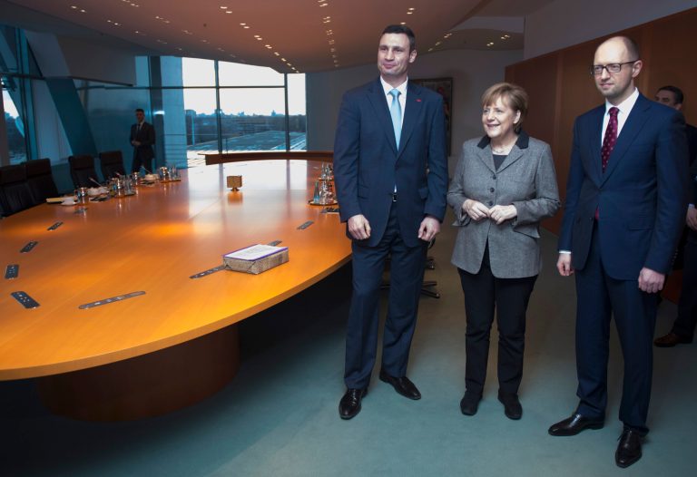 German Chancellor Angela Merkel, center, welcomes Ukraine opposition leaders Vitali Klitschko, left, and Arseniy Yatsenyuk, right, Monday,  Feb. 17, 2014 at the chancellery in Berlin to discuss the country's crisis. The former Soviet nation has been in chaos since November when President Viktor Yanukovych ditched a planned EU trade and political pact in favor of closer ties with Moscow. (AP Photo/Jogannes Eisele, Pool)